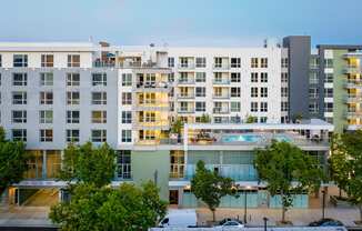 an aerial view of an apartment building with a pool in front of it
