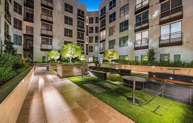 Tranquil courtyard with landscaped greenery, intimate seating, and modern design for outdoor gatherings