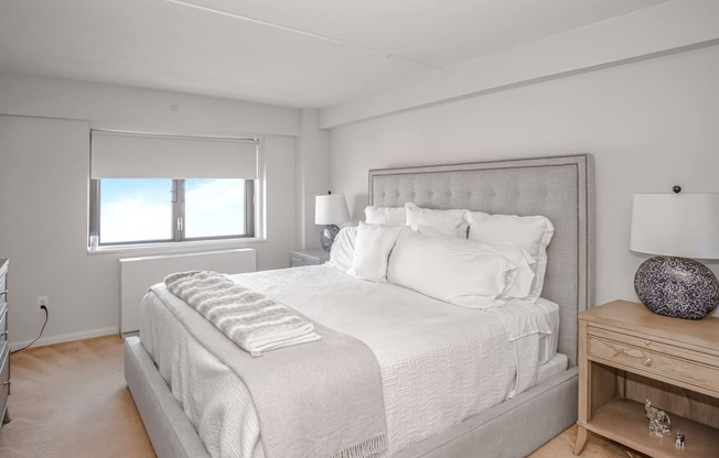 a bedroom with a large bed and a window
