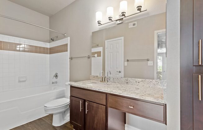 a bathroom with a toilet sink and bathtub at The Verandah, Texas, 78726