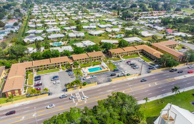 an aerial view of a city with a pool and parking lot