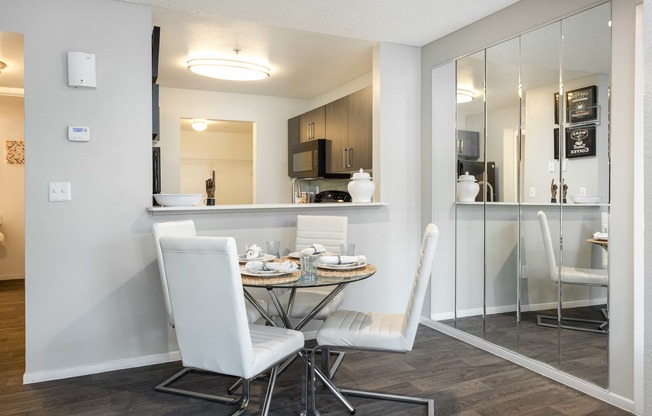 a dining room with a table and chairs and a kitchen