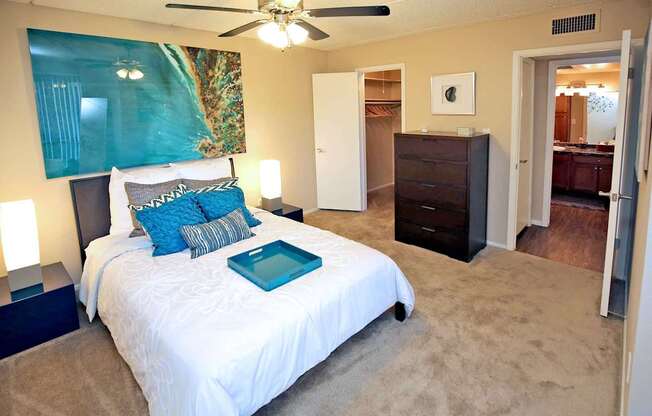 a bedroom with a bed and a ceiling fan
