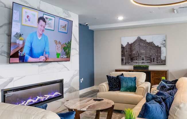 A living room with a fireplace and a television on the wall.