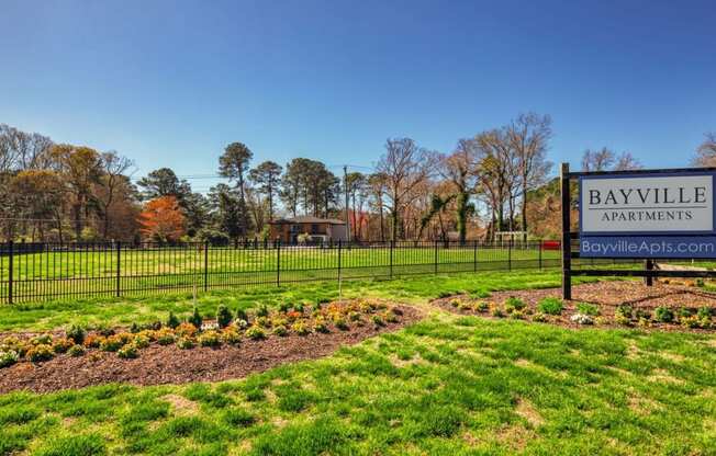 a park with a sign apartments  at Bayville Apartments, Virginia Beach, VA, 23455