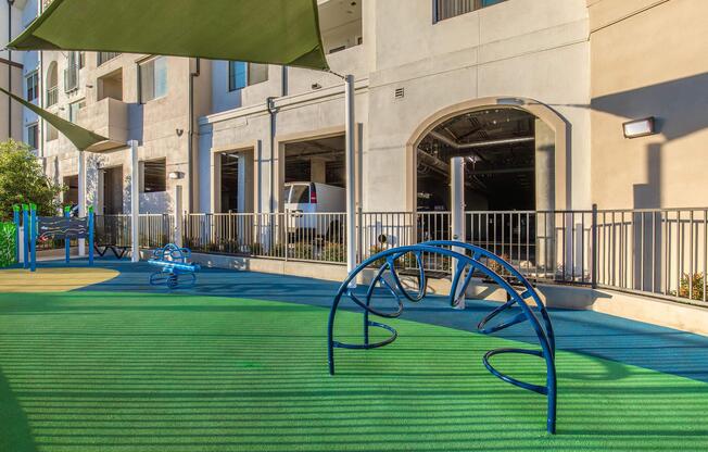 a green bench sitting in front of a building