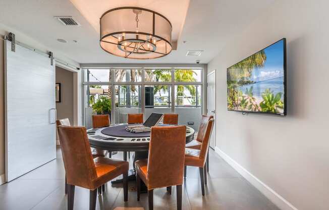 a dining room with a table and chairs and a large window