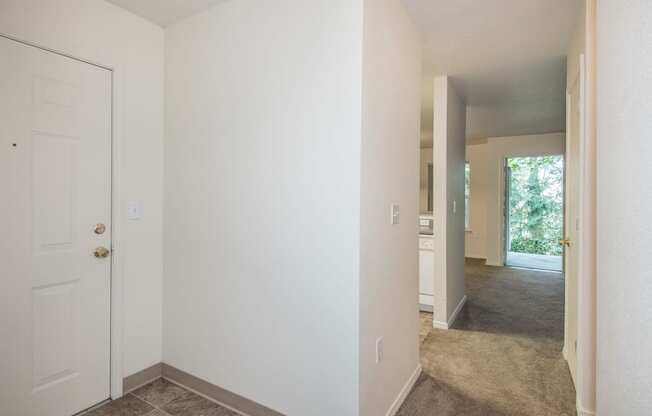 a bedroom with a white door and carpeted floor