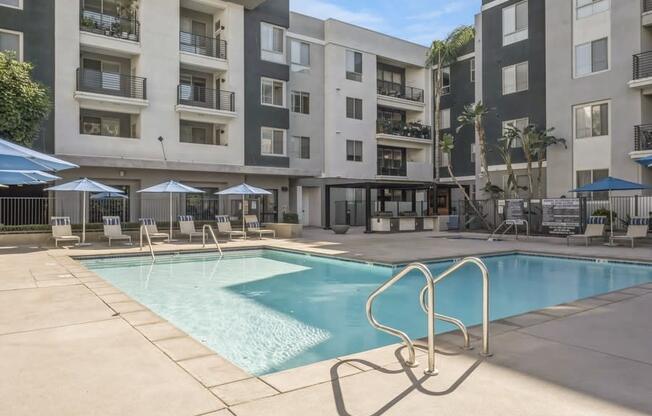 a swimming pool in front of an apartment building