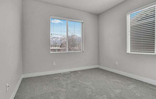 A room with a window showing a snowy landscape outside.