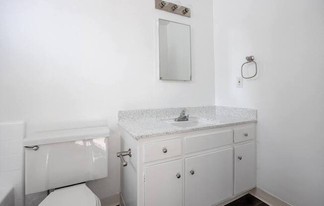 an empty bathroom with a sink and a toilet