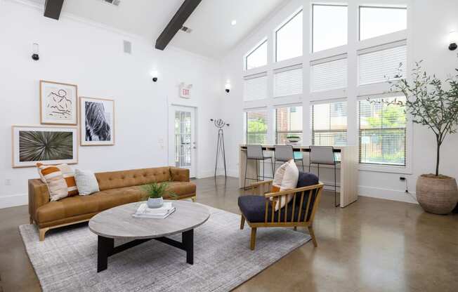 a living room with white walls and ceilings and a large window