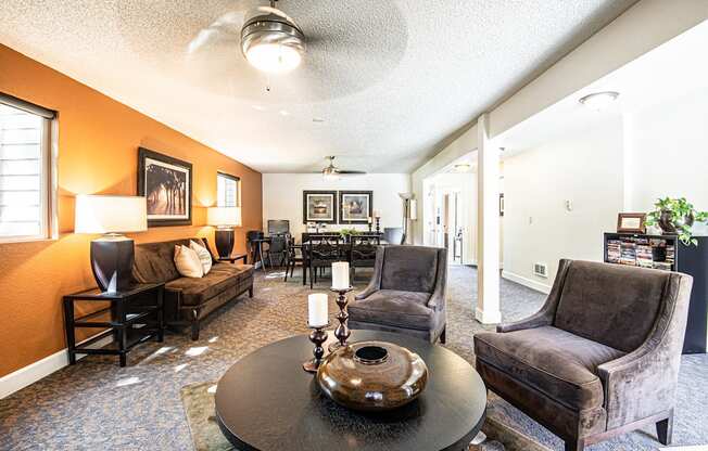 a living room with couches and chairs and a table at Eagles Landing Apartments, Everett, WA