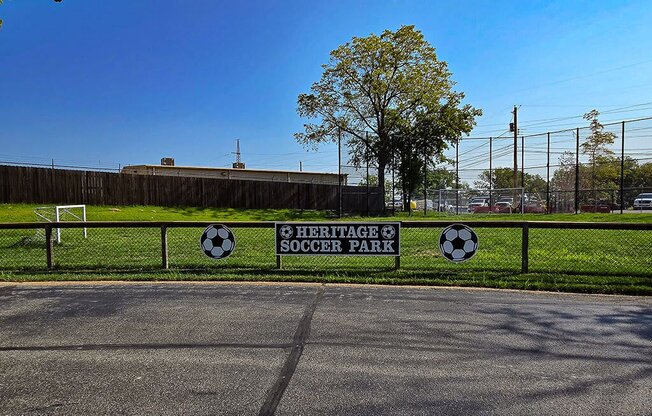 a soccer park with a sign on a fence