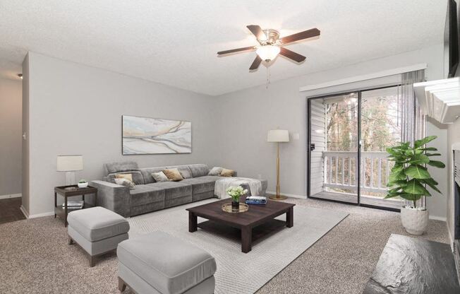 a living room with a ceiling fan and a couch