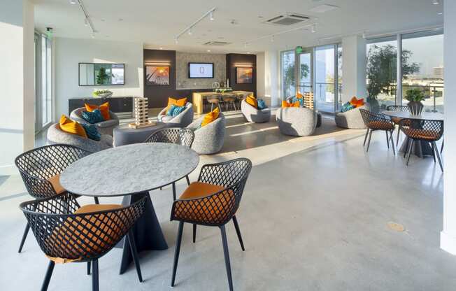 the lobby of an office building with tables and chairs