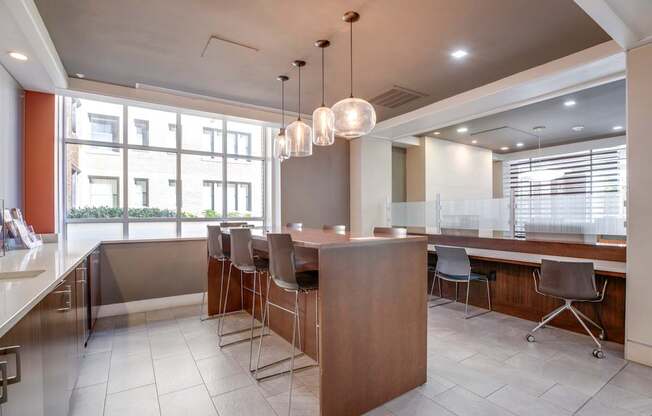 A modern kitchen with a large island and bar stools.