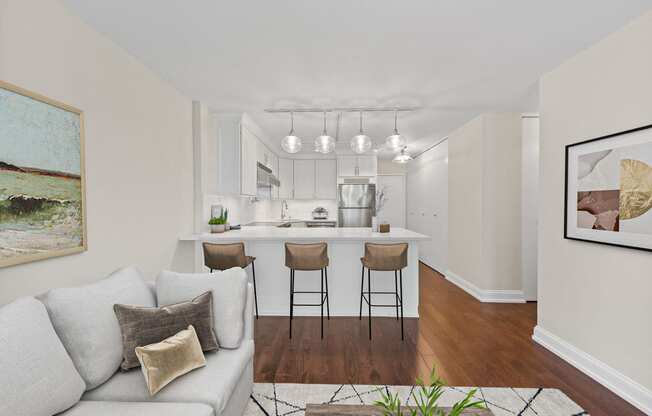 a living room with a couch and a kitchen with a bar
