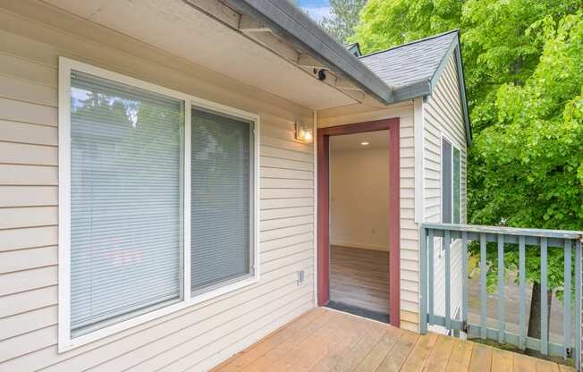 a balcony with a door that leads to a hallway