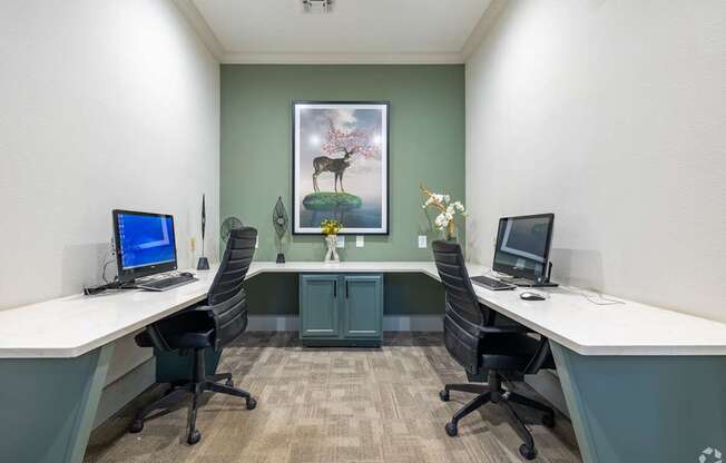 A room with two desks and two chairs.