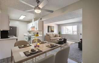 A modern kitchen with a dining table set for two.