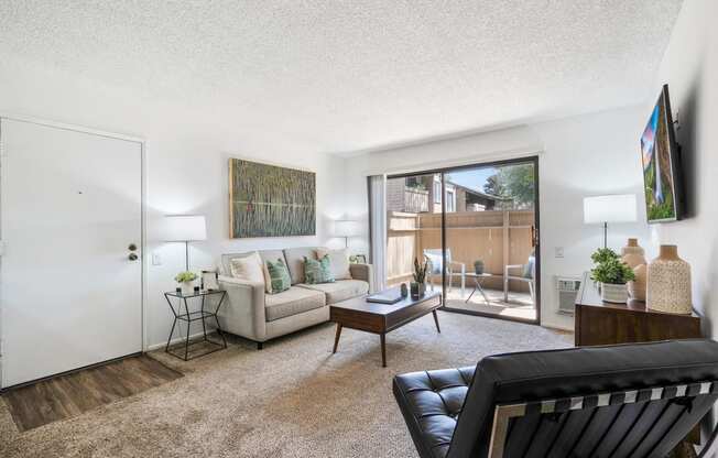 a living room with a couch and a sliding glass door