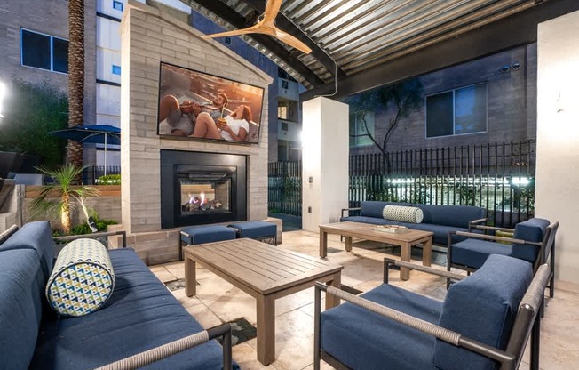 A patio with a fireplace and seating area.