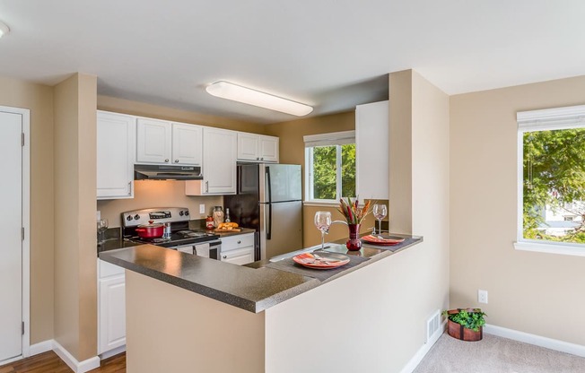 a kitchen with a island and a stove and a refrigerator at Springfield, Renton, 98055