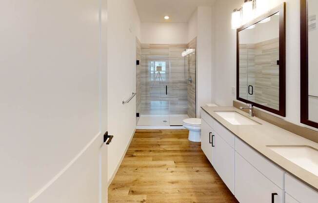 A long, narrow hallway with a toilet and sink visible.