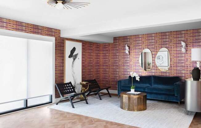 a living room with a blue couch and a brick wall