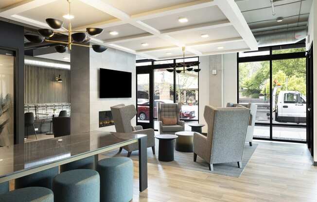 the lobby of a hotel with chairs and a table