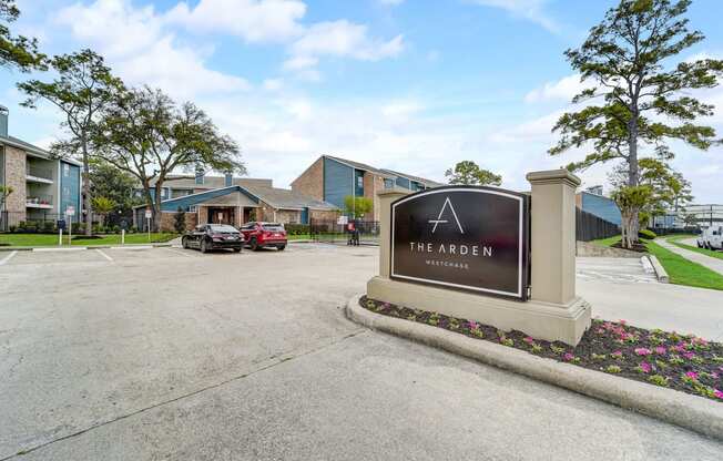 the arden apartments entrance sign with parking lot and buildings