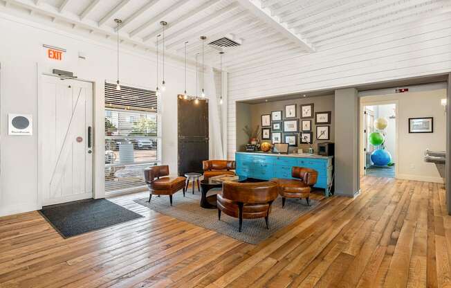 a living room with a table and chairs and a blue cabinet
