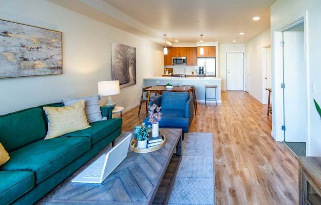 A living room with a green couch and a coffee table.