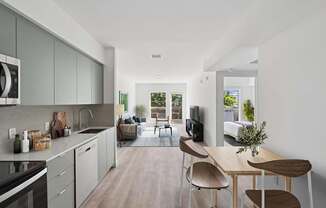 A modern kitchen with a dining table and chairs.