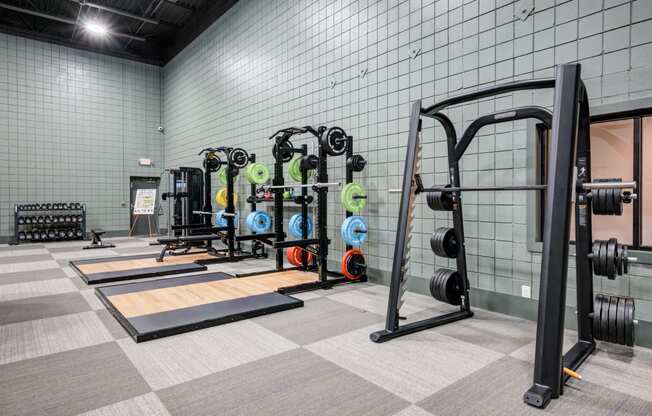 the weights room in the new fitness center at the house