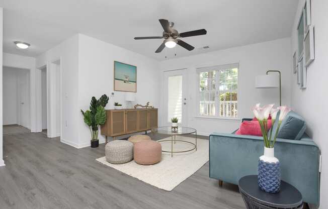 a living room with a blue couch and a ceiling fan