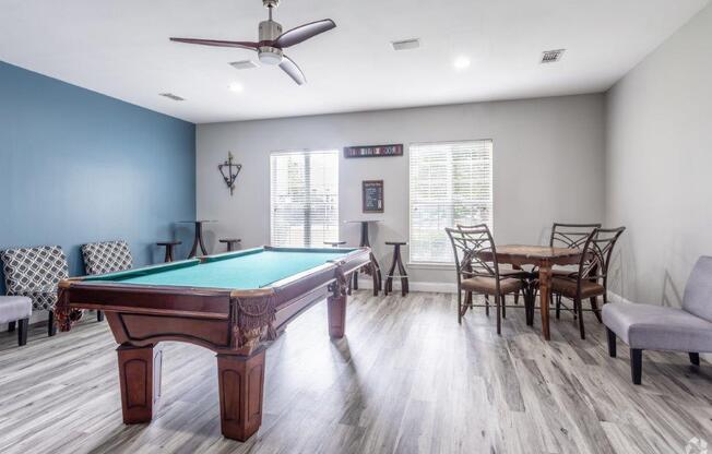 a games room with a pool table and a dining room