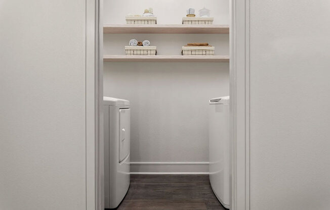 A white refrigerator with a drawer and shelves inside.
