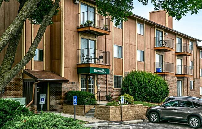 an apartment building with a car parked in front of it