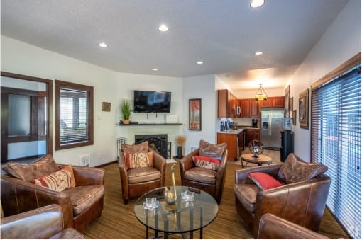 a living room with couches and chairs and a table