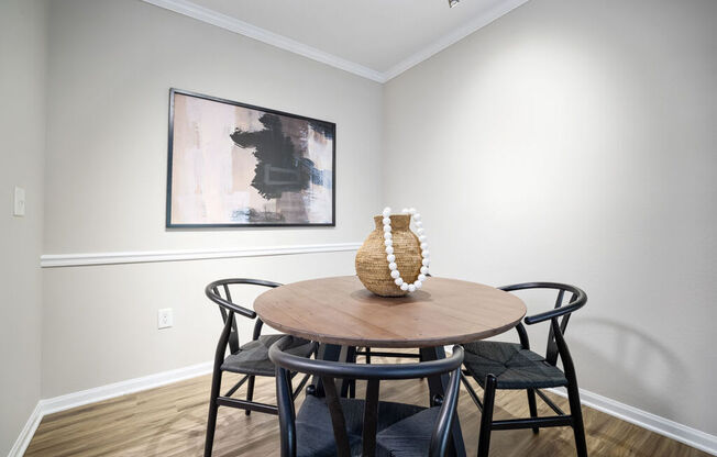 a dining room with a table and three chairs