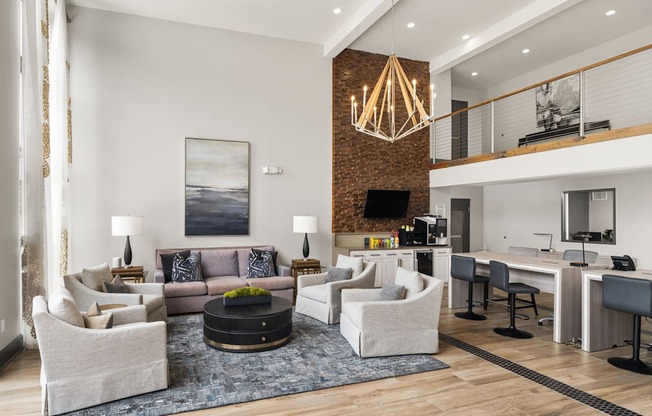 a living room with couches and chairs and a dining room table and a kitchen