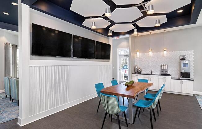 a conference room with a wooden table and blue chairs