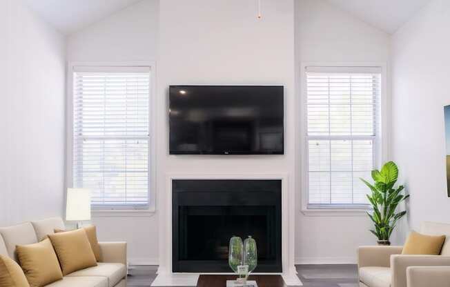 a living room with couches and a table and a ceiling fan