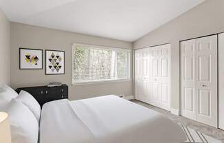A bedroom with a white bed and two framed pictures on the wall.