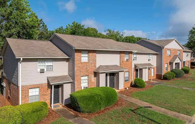 A row of houses with a clear blue sky above them.