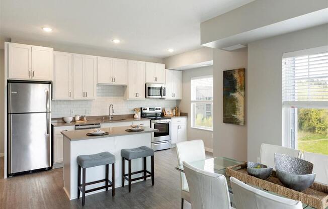 A modern kitchen with white cabinets and a glass table.