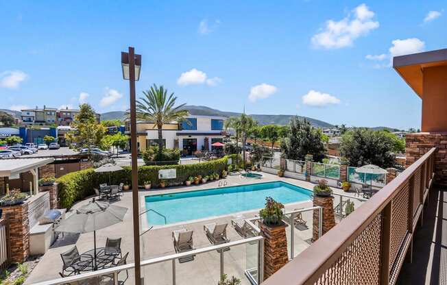 a view of the pool from a balcony at the resort