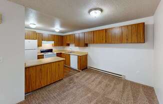 Spacious kitchen area at Heritage Grove Apartments Renton WA featuring timber-style cabinets, ample counter space, and overhead lighting.